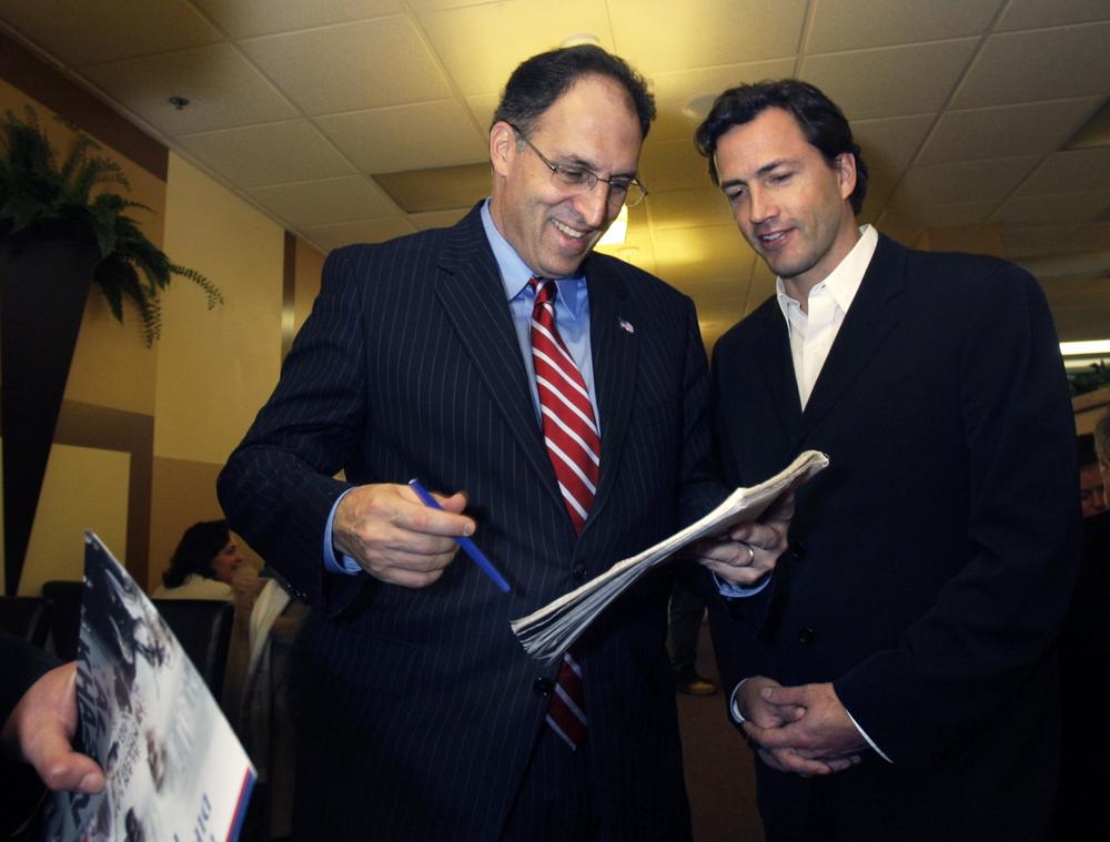 Alan Khazei signs an autograph during a campaign stop at the Z Cafe in Worcester as supporter and actor Andrew Shue looks on. (AP) 