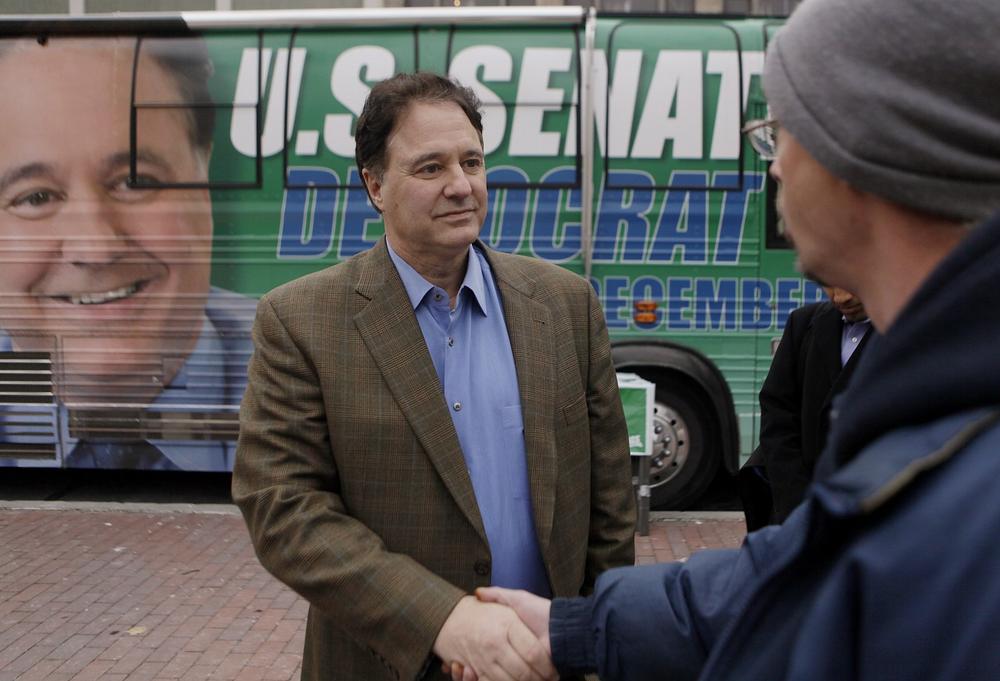 Stephen Pagliuca shakes a man's hand as he campaigns in Copley Square in Boston on Monday. (AP)