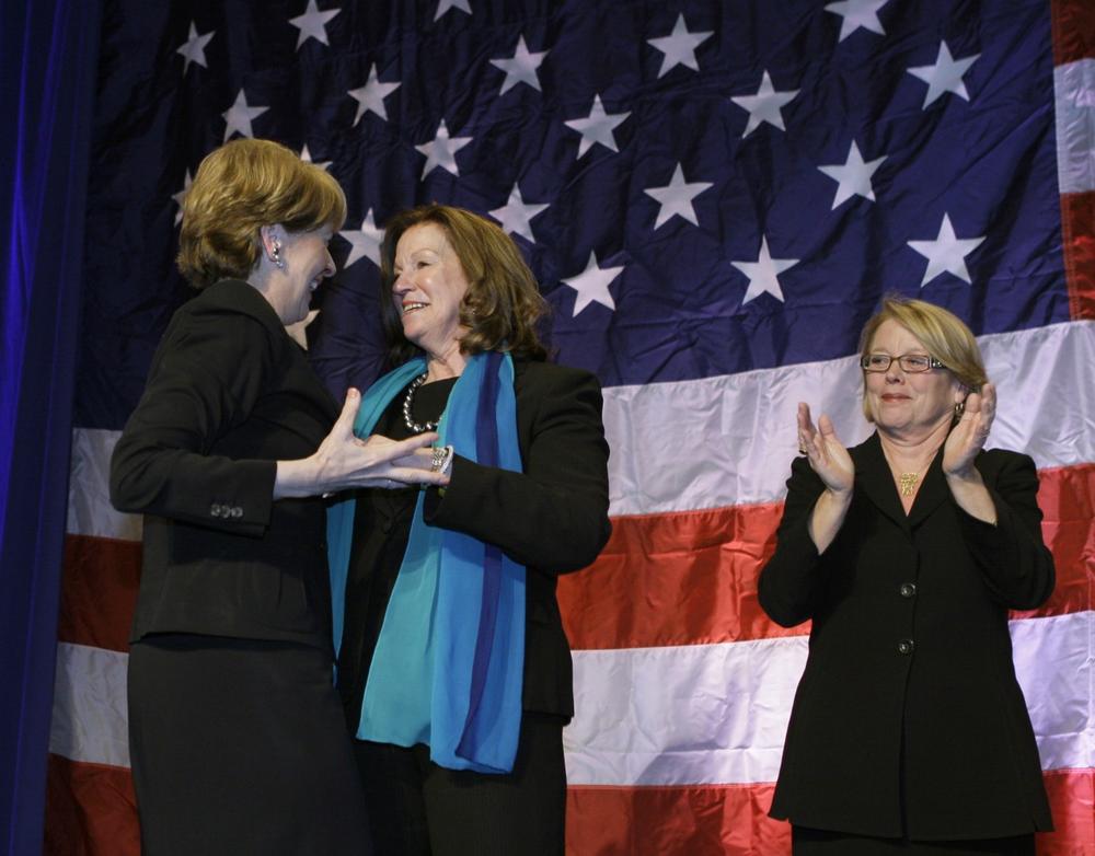 Coakley is greeted on stage by Massachusetts Senate President Therese Murray and Rep. Niki Tsongas, right. (AP)