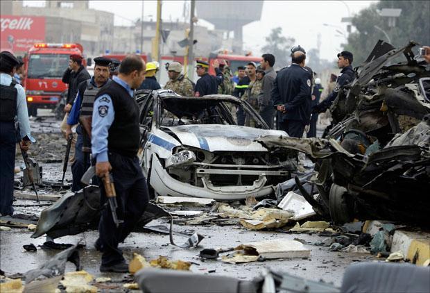 Iraqi security forces gather at the site of a bomb attack near the Labor Ministry building in Baghdad. (Hadi Mizban/AP)