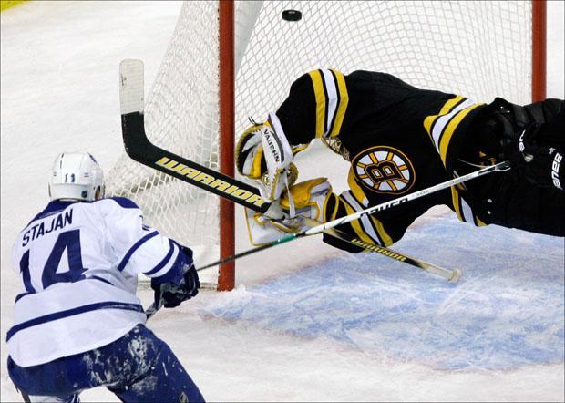 Goalie Tuukka Rask dives to try to make a save on a shot by Toronto Maple Leafs&#039; Matt Stajan during the third period on Thursday. (Charles Krupa/AP)
