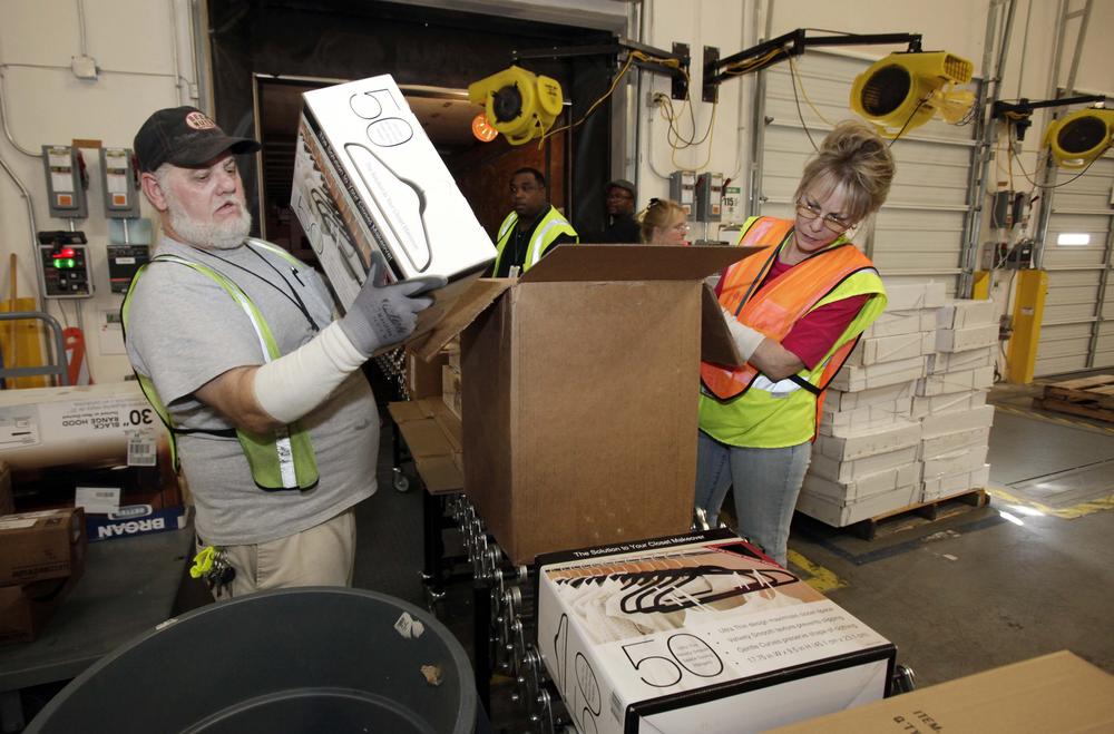 Workers unpack a truck inside the 800,000 sq. ft. Amazon.com warehouse in Goodyear, Ariz, Nov. 16, 2009,. (AP)