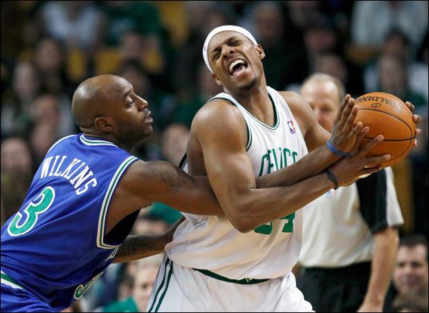 Boston Celtics&#039; Paul Pierce, right, holds on to the ball under pressure from Minnesota Timberwolves&#039; Damien Wilkins in the fourth quarter on Sunday. (AP)