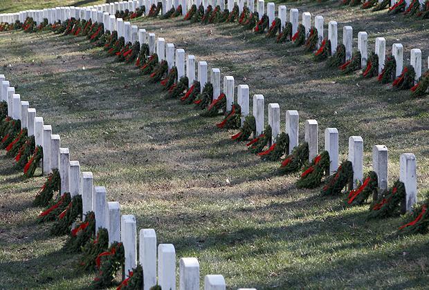 Wreaths are placed at graves as part of Wreaths Across America at Arlington National Cemetery in Arlington, Va. on Dec. 12. More than 16,000 wreaths were placed at graves throughout the cemetery. (AP)