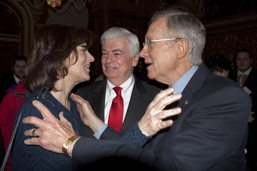 Victoria Kennedy, widow of Sen. Ted Kennedy hugs Senator Majority Leader Harry Reid of Nev. on Capitol Hill in Washington, Thursday, Dec. 24,2009, as Sen. Banking Committee Chairman Sen. Christopher Dodd, D-Conn, looks on at center, after the Senate passed the health care reform bill. (AP)