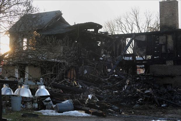 The remains of a house fire on 17 Fair St. as seen on Sunday. (Jessica Hill/AP)