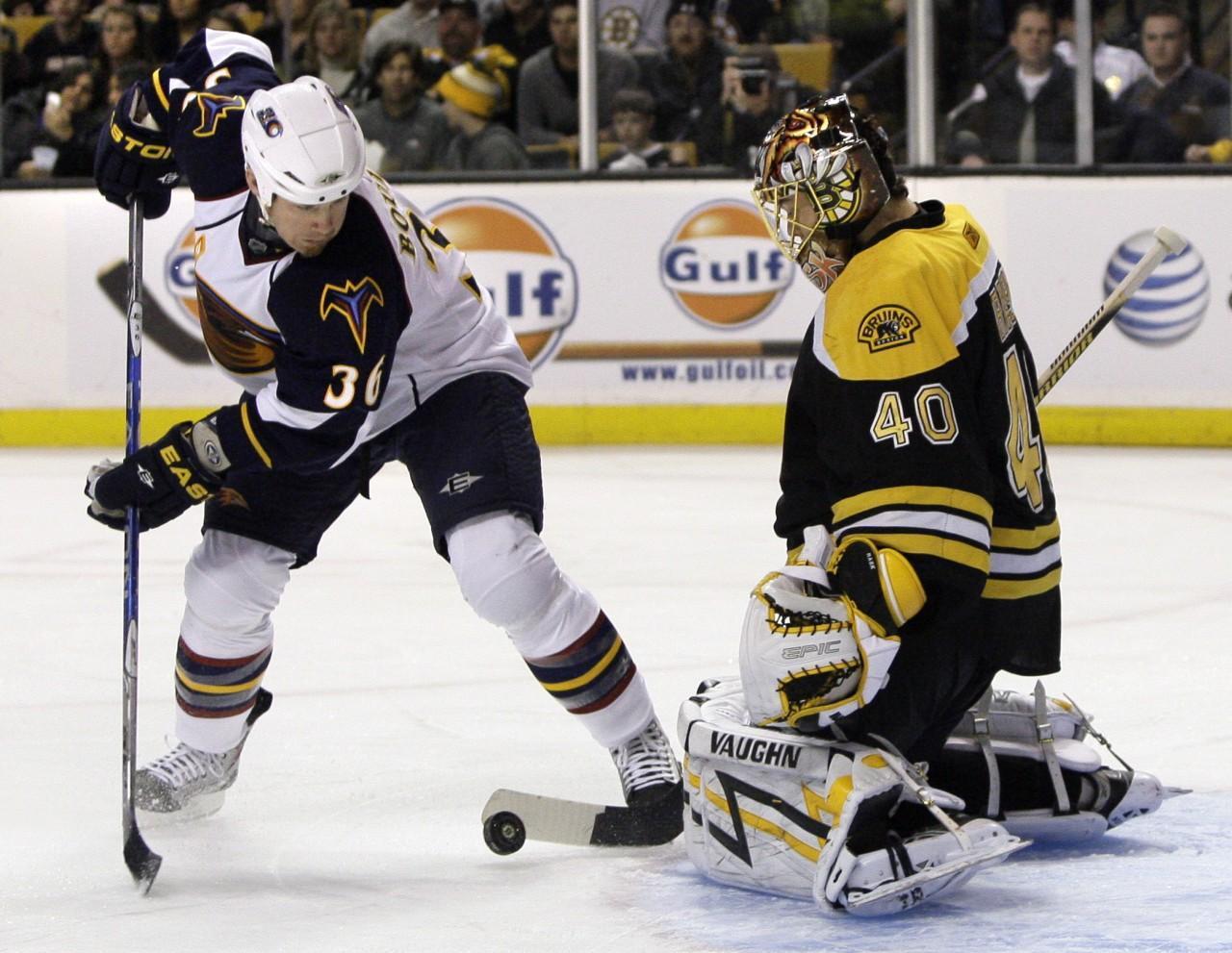 Boston Bruins goalie Tuukka Rask makes a save on an attempt by Atlanta Thrashers left wing Eric Boulton during the first period of an NHL hockey game in Boston on Wednesday. (AP)