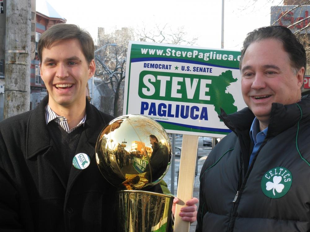 Steve Pagliuca with his son, holding the Celtics championship trophy, in Harvard Square.