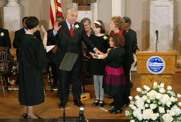 Menino is sworn in with his wife, Angela, and his grandchildren. (Andrew Phelps/WBUR)