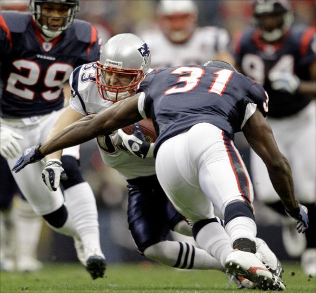 Patriots wide receiver Wes Welker is hit by Houston Texans safety Bernard Pollard (31) after a catch good for a first down on Sunday. (David J. Phillip/AP)
