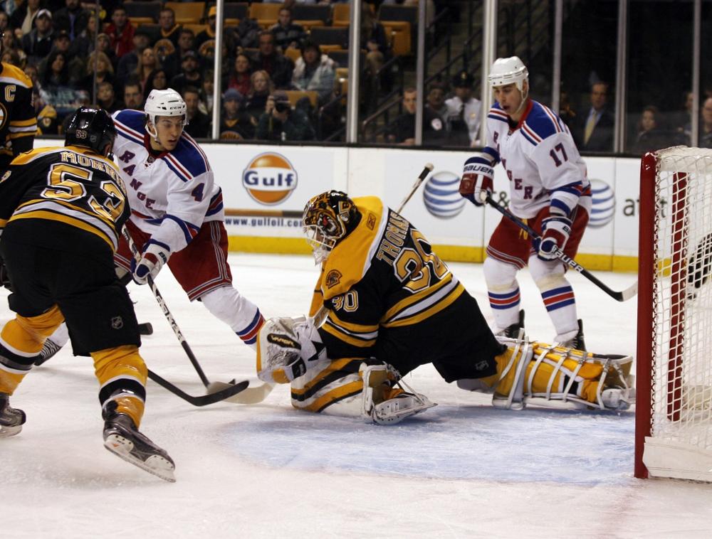 New York Rangers&#039; Michael Del Zotto (4) scores a goal past Boston Bruins goalie Tim Thomas (30) as  Rangers&#039; Brandon Dubinsky (17) and Bruins&#039; Derek Morris (53) look on during the first period on Saturday in Boston. (AP Photo/Mary Schwalm)