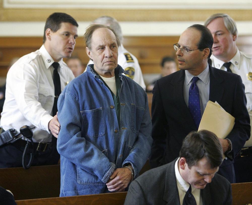 Norman Porter, second from left, listens to his lawyer during his arraignment in Dedham Superior Court in Dedham in March 2005. Porter's whereabouts had been a mystery to police since he walked away from a pre-release center in December 1985. He was arrested in Chicago on Tuesday after a tipster in Massachusetts told police that Porter was living there. (AP)