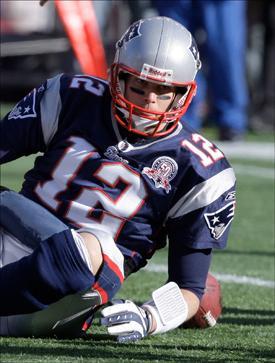 Tom Brady picks himself up off the turf during an NFL wild-card playoff football game against the Baltimore Ravens in Foxborough, Mass., on Sunday. (Charles Krupa/AP)