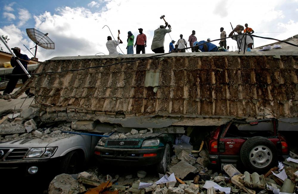 People search for survivors under the rubble of a collapsed building the day after an earthquake hit Port-au-Prince, Haiti, Wednesday, Jan. 13, 2010.  (AP)