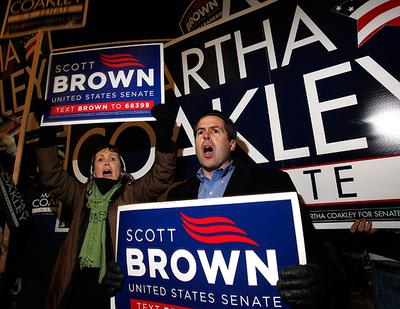 Supporters for Republican Scott Brown position themselves in front of signs for Democratic candidate Martha Coakley on the street outside the venue of a debate on the campus of the University of Massachusetts, in Boston, on Monday, Jan. 11.  (AP)