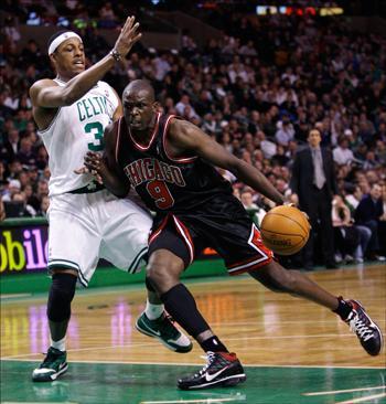 Chicago Bulls forward Luol Deng drives to the basket against Celtics forward Paul Pierce on Thursday. (Charles Krupa/AP)