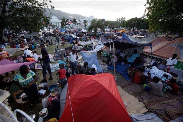 Earthquake survivors make camp outside the damaged National Palace in Port-au-Prince on Thursday. (AP)