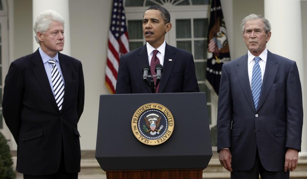 President Barack Obama, center, speaks about Haiti as former presidents Bill Clinton, left, and George W. Bush, right, listen in the Rose Garden at the White House in Washington Saturday. (AP Photo/Pablo Martinez Monsivais)