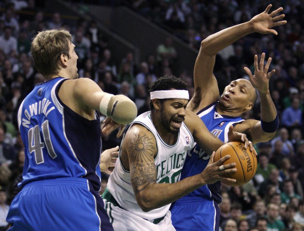 Boston Celtics center Rasheed Wallace, center, splits Dallas Mavericks forward Dirk Nowitzki, left, of Germany, and forward Shawn Marion on a drive to the basket in the second quarter of Monday night's game in Boston. (AP Photo/Charles Krupa)