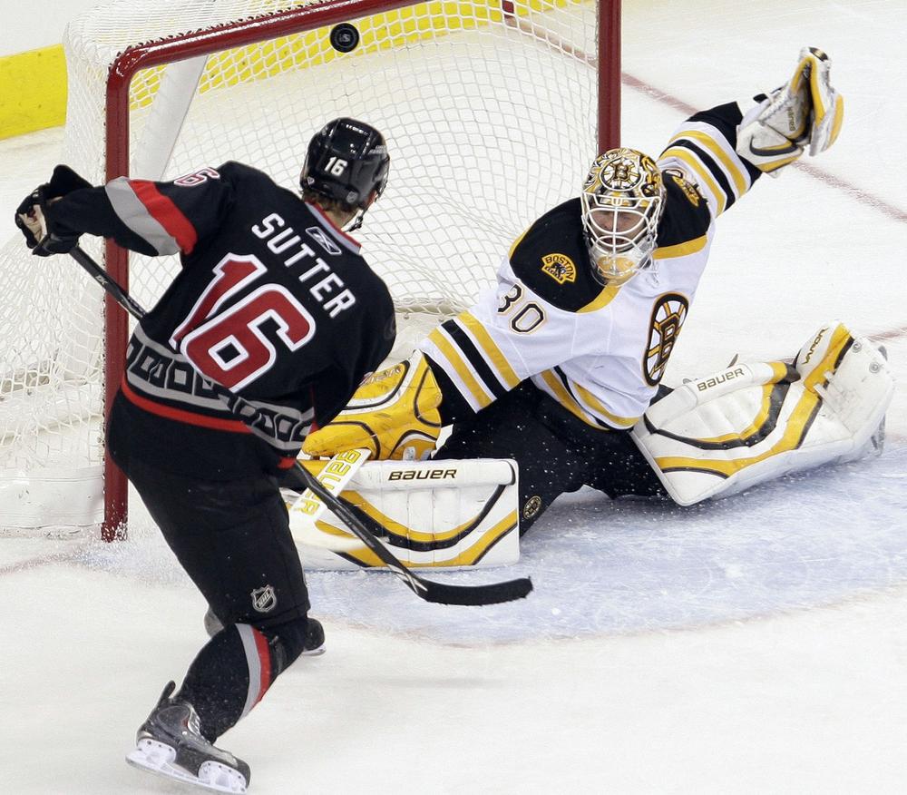 Carolina Hurricanes' Brandon Sutter scores on Boston Bruins goalie Tim Thomas during the second period in Raleigh, N.C. on Sunday. (AP)
