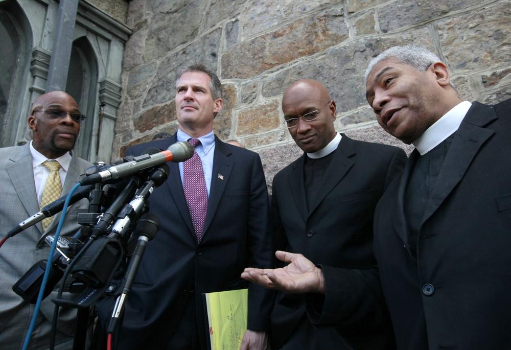 Sen.-elect Scott Brown listens as Rev. Eugene Rivers, right, speaks with members of the media as Rev. Hurmon Hamilton, left, and  Rev. Ray Hammond, second from right, outside the Roxbury Presbyterian Church in Boston, Tuesday. (AP)