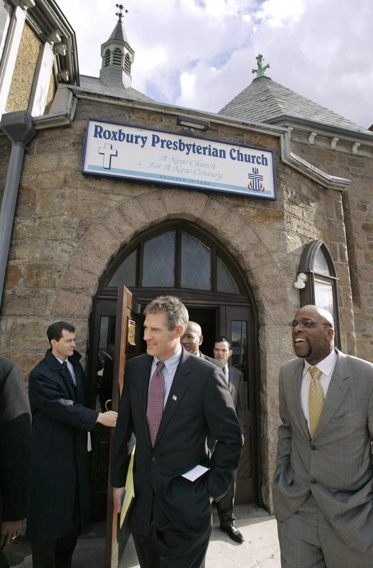 Brown emerges from the Roxbury Presbyterian Church with Rev. Hamilton, right, the senior pastor. (AP)