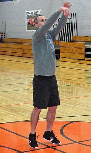 Cummings stands at the line at the Epsom Center School in Epsom, N.H. He shoots foul shots for an average of two hours per day. (Doug Tribou/WBUR)