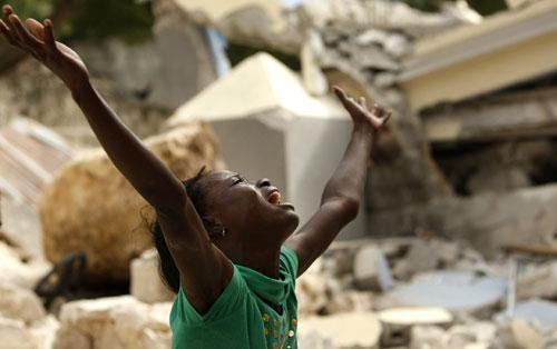 A girl screams after seeing the feet of her dead brother in the rubble of the collapsed St. Gerard School in Port-au-Prince, Haiti, on Thursday, Jan. 14, 2010. (AP)