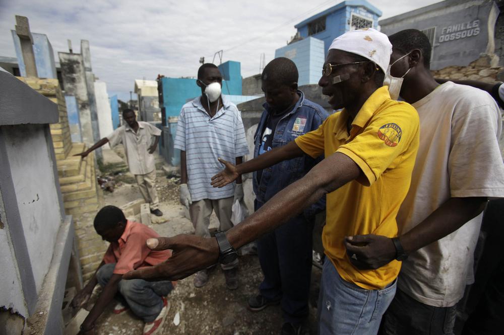 A man mourns during the funeral of his 3-year-old daughter who died in Tuesday's earthquake in Port-au-Prince, Thursday, Jan. 14, 2010. An earthquake measuring more than 7 on the Richter scale hit Haiti on Tuesday leaving thousands dead. (AP)