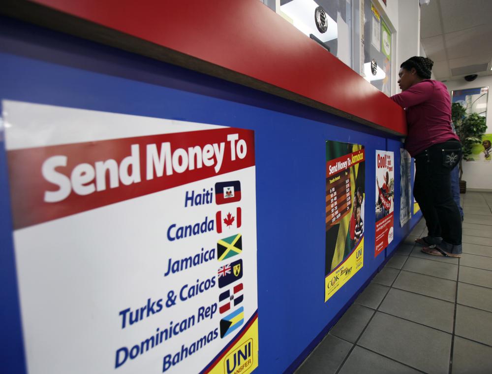 A customer stand at the counter at Unitransfer, a money transfer company, Tuesday, Jan. 19, 2010 in the Little Haiti neighborhood of Miami.   (AP)