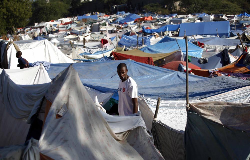 A man stands among tents made of bedsheets, tarps and sticks in a makeshift refugee camp in Port-au-Prince, Monday, Jan. 25, 2010.  (AP)
