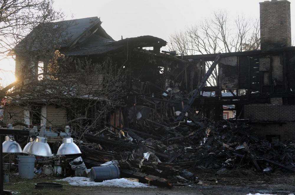 The remains of the house fire on 17 Fair St. where a father and son died early Sunday morning. (AP)