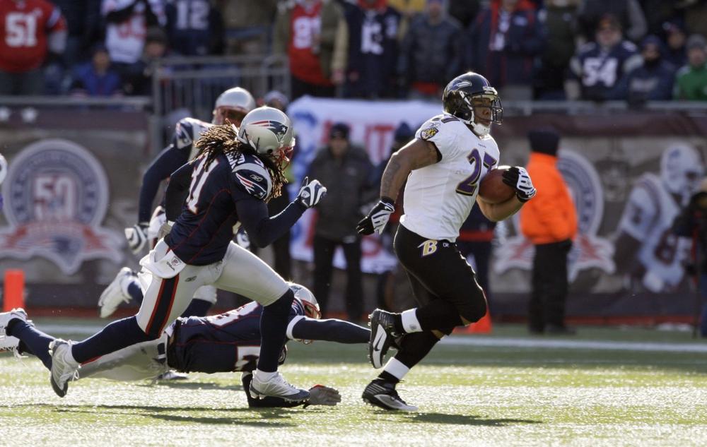 Baltimore Ravens running back Ray Rice breaks free from New England Patriots Brandon Meriweather (31), Leigh Bodden, center, and James Sanders, to score a touchdown on the first play from scrimmage during the first quarter of their NFL wild-card playoff football game in Foxborough.  The Ravens ran away with the game, 33-14. (AP)