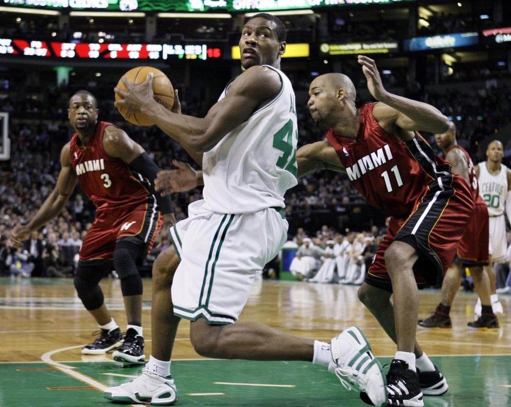 Boston Celtics guard Tony Allen (42) looks to make a move against the defense of Miami Heat guard Rafer Alston (11) as Heat guard Dwyane Wade (3) looks on in the second half of Wednesday&#39;s game. (AP Photo/Elise Amendola)