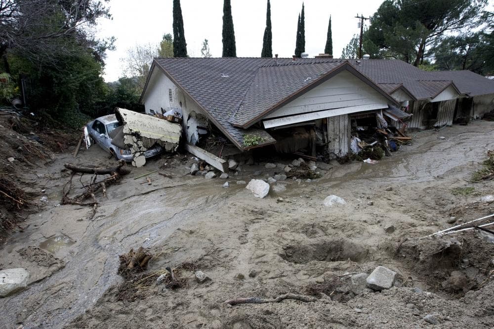 A house is covered by mud and debris after a mudslide in La Canada Flintridge, Calif., on Saturday. (AP Photo/Hector Mata)
