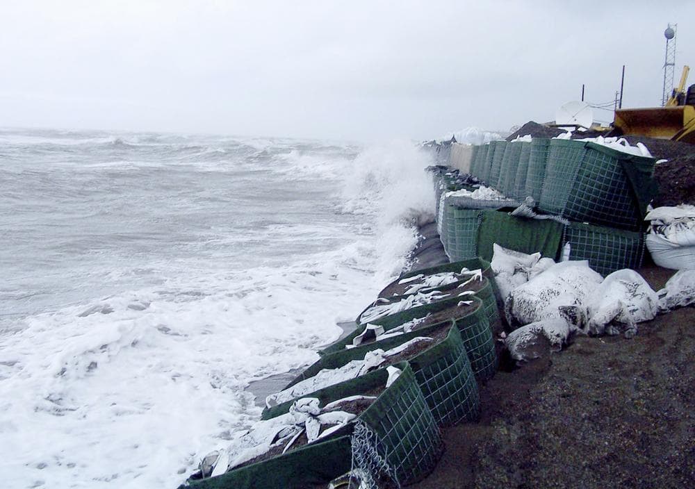 Waves pound the sandbagged seawall in Kivalina, Alaska, Sept., 2007. (AP)