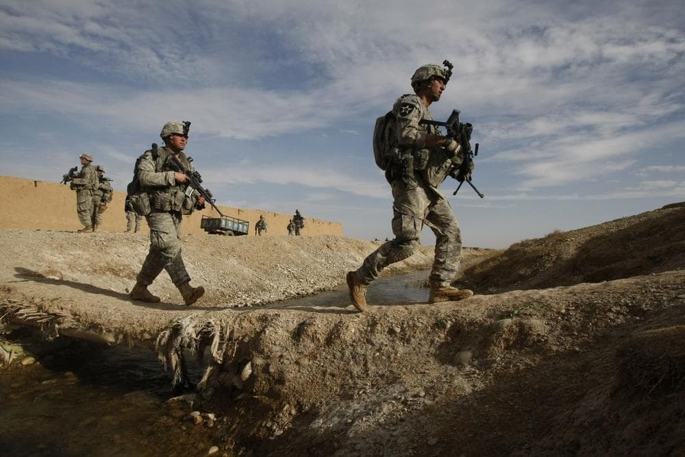 U.S. soldiers of the 4th Battalion, 23rd Infantry Regiment, 5th Brigade, 2nd Infantry Division, cross a canal west of Lashkar Gah in Helmand province, southern Afghanistan, Friday, Feb. 12, 2010. This unit is operating in support of a planned U.S. Marine offensive against the Taliban in Marjah area. (AP)