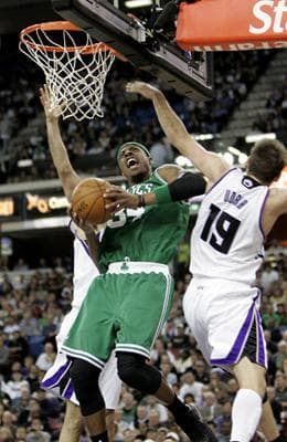Boston Celtics forward Paul Pierce, left, goes to the basket against Sacramento Kings guard Beno Udrih, of Slovenia, right, during the fourth quarter of Tuesday's game.(AP Photo/Rich Pedroncelli)