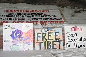 Tibetans at the Harvard Square vigil bring signs and banners, expressing their cause.  (Karen Pelland/WBUR)