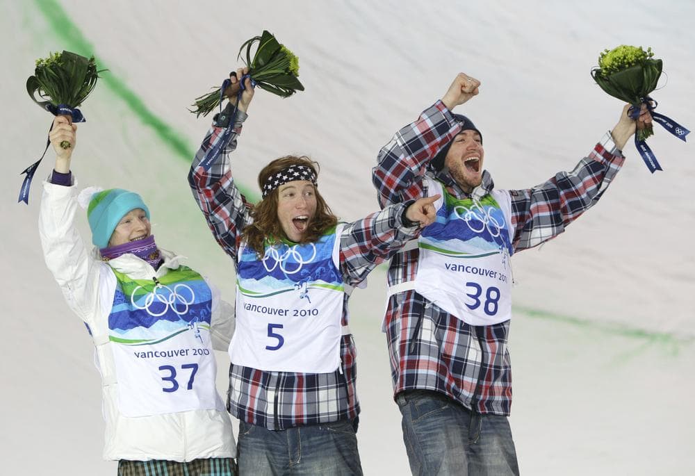 Olympic Champion Shaun White of the USA, center, runner up Peetu Piiroinen of Finland, left and third placed Scott Lago of the USA celebrate at the flower ceremony after the men&#039;s snowboard halfpipe competition at the Vancouver 2010 Olympics in Vancouver, British Columbia, Wednesday, Feb. 17, 2010. (AP Photo/Gerry Broome)