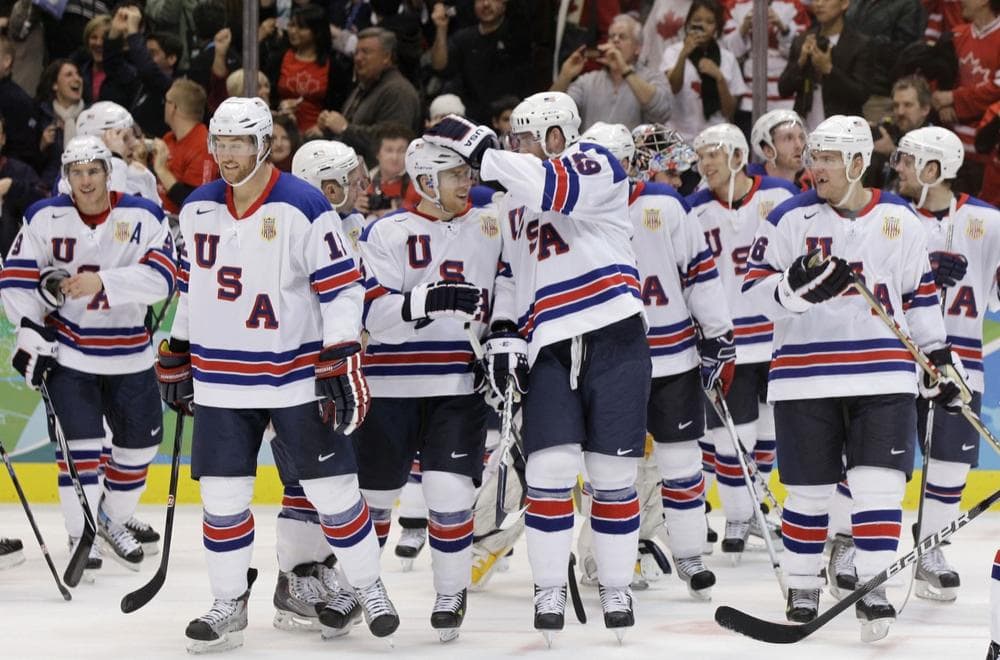 The United States&#39; Ryan Malone (12), Joe Pavelski (16) and Ryan Whitney (19), center, congratulate one another after beating Canada 5-3 in Sunday&#39;s game. (AP)