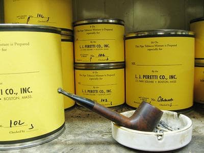 The yellow tins at L.J. Peretti Co. contain custom hand-blended pipe tobacco. (Karen Pelland for WBUR)