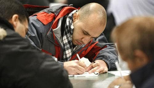 Job applicants fill out forms at a job fair in Santa Clara, Calif., on Jan. 23, 2010. (AP)