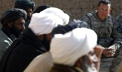 U.S. Army Lt. Col. Burton Shields, commander of the 4th Battalion, 23rd Infantry of Task Force Stryker, sits during a meeting, or shura, with village leaders in the Badula Qulp area, West of Lashkar Gah in Helmand province, southern Afghanistan, Tuesday, Feb. 16, 2010. (AP)