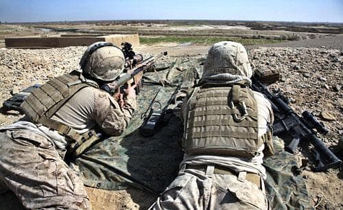 U.S. Marines with NATO forces keep vigil as Marines and Afghan National Army (ANA) soldiers set up a joint military base north of Marjah, Helmand province, on Thursday, Feb. 18, 2010. (AP )