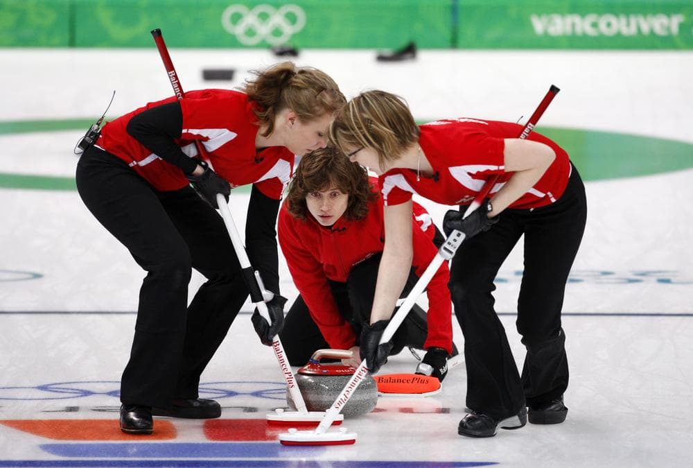 Swiss skip Mirjam Ott delivers the stone to sweepers Irene Schoriin (l) and Janine Greiner in a curling match against the U.S. Tuesday in Vancouver. (AP Photo)