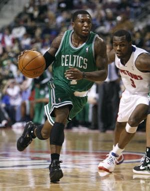 Celtics guard Nate Robinson drives around Pistons guard Rodney Stuckey during Tuesday&#39;s game. (AP)