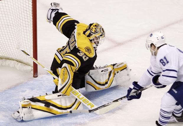 Bruins goalie Tim Thomas, left, makes a save on a shot by Maple Leafs right wing Phil Kessell during Thursday&#039;s game in Boston. (AP)