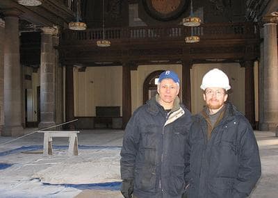 Richard Thal, left, and Brian Goldson stand within the under-construction Blessed Sacrament church in Jamaica Plain. (Monica Brady-Myerov/WBUR)