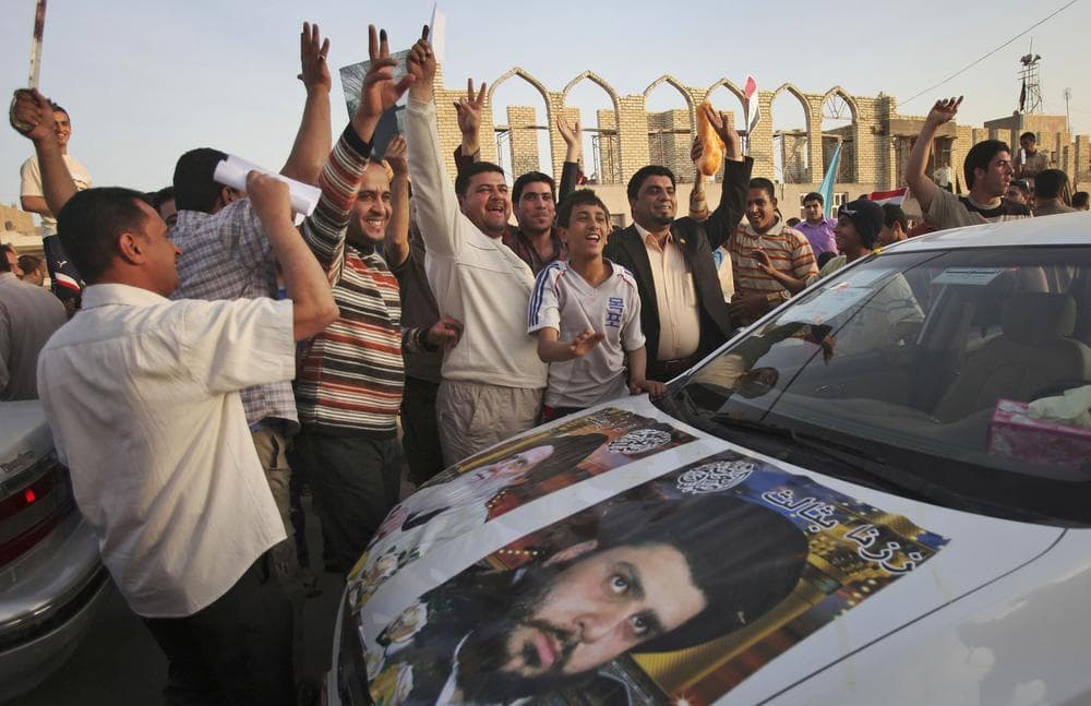 Supporters of anti-American Shiite cleric Muqtada al-Sadr celebrate on the streets of Sadr City in Baghdad, Iraq today (AP)